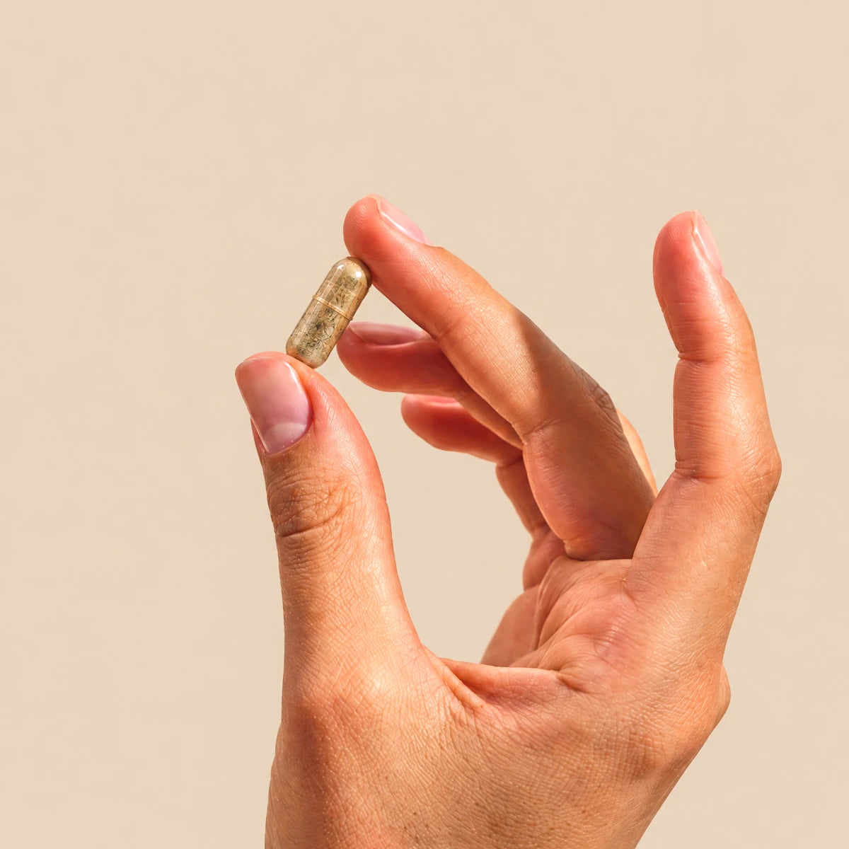 capsula di Liposan Forte Nuova Formula tenuta tra le dita